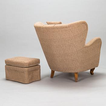 A mid-20th-century armchair and ottoman.