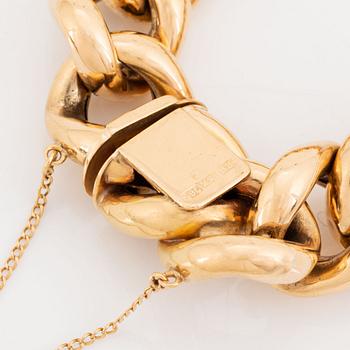 An 18K gold bracelet.