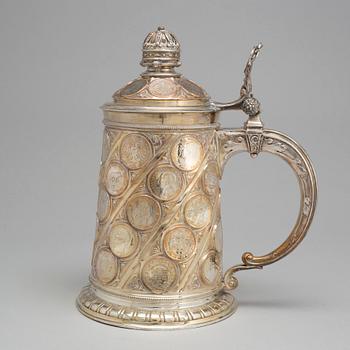 A late 19th century EPNS tankard with silver coins.