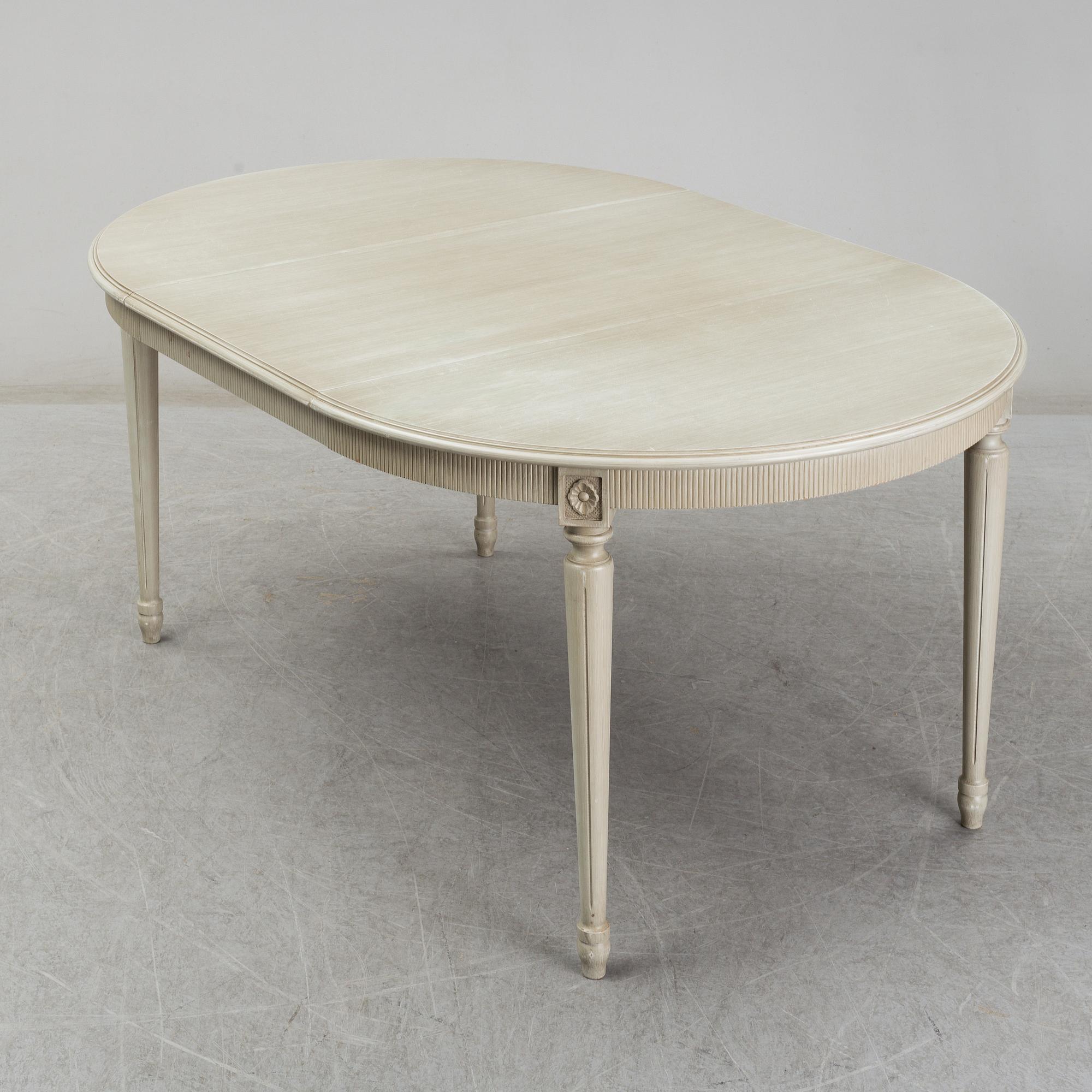 A dining table and six chairs, Gustavian style, second half of the 20th century. One leaf included.