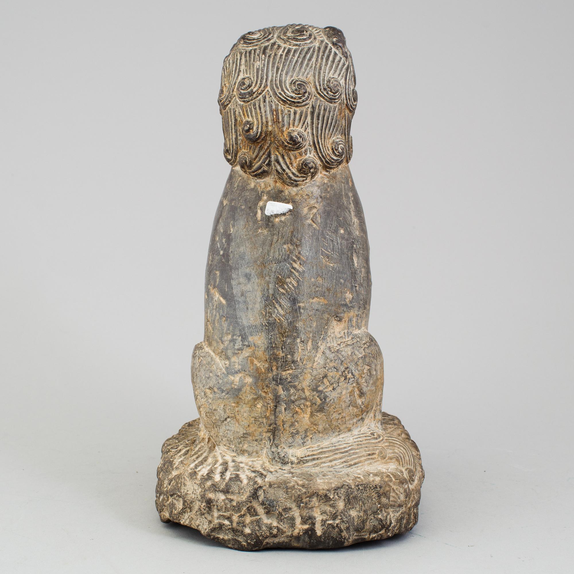 A stone sculpture of a mythical beast, China, 20th Century.