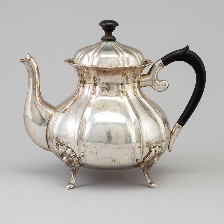 A silver rococo style teapot.