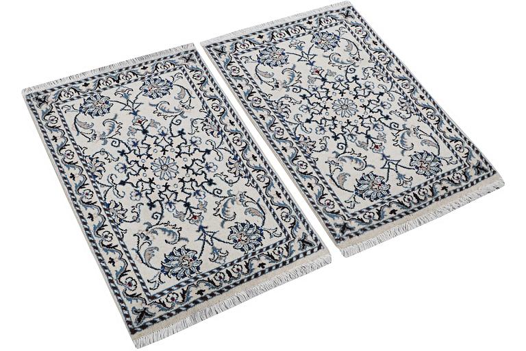 A pair of Nain rugs, part silk, c. 88 x 57 cm & c. 89 x 57 cm.