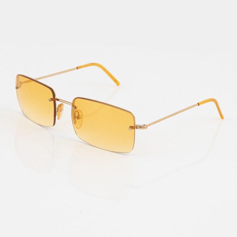 Gucci, a pair of gold and orange-toned glasses.