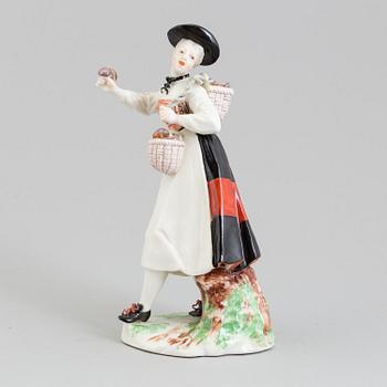 A Nymphenburg porcelain figure of a mushroom sales woman, Germany, 20th Century.