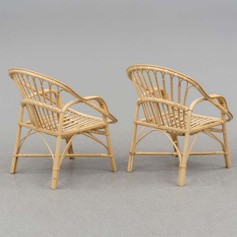 A pair of late 20th century rattan easy chairs.