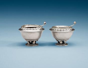 705. A pair of Georg Jensen salt cellars with spoons, Copenhagen 1925-33.