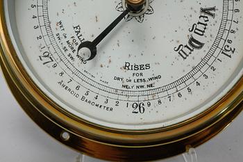 A wall clock from Smith Empire and a barometer, made in the fourth quarter of the 20th century.