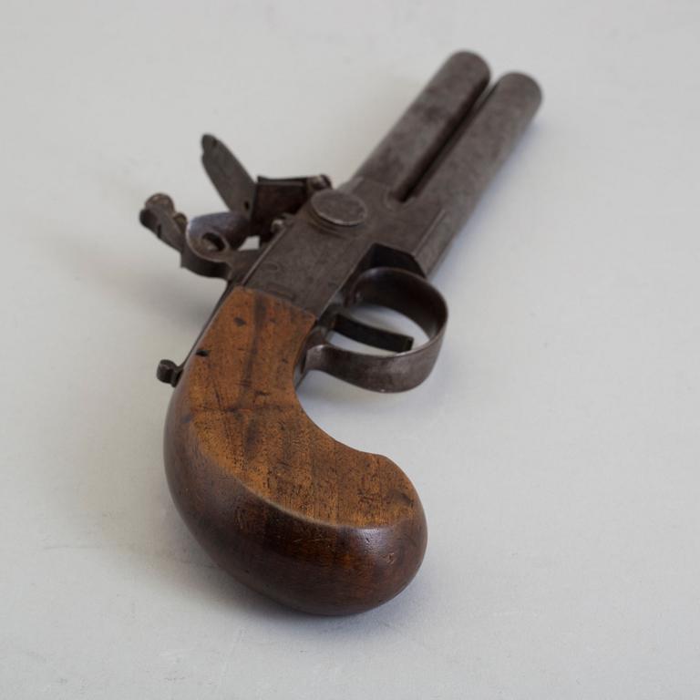 A British over-and-under flintlock pistol circa 1800.