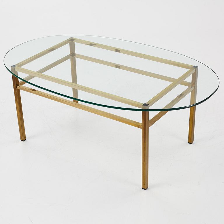 A 1970's glass and brass coffee table.