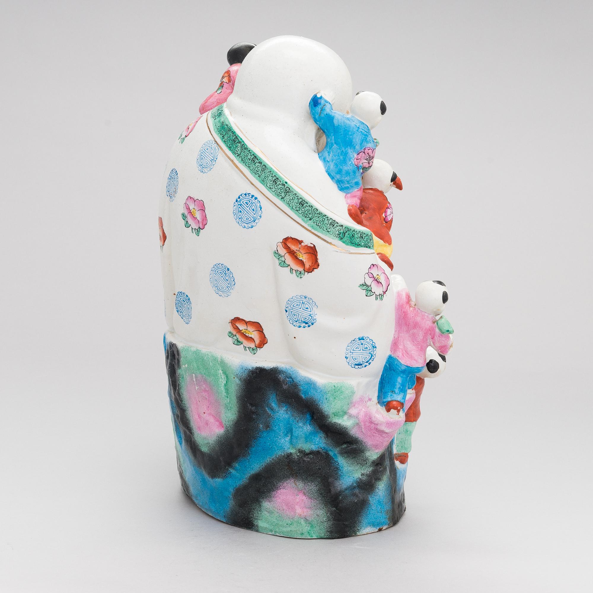A Chinese porcelain laughing buddha with children, the 20th century.