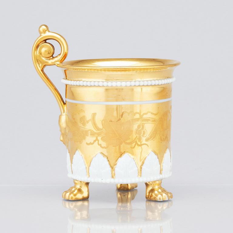 A gilded French Empire cup with stand, 19th Century.