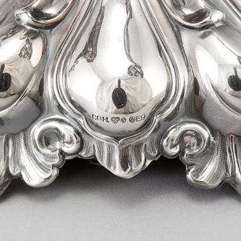 A pair of Swedish Rococo style silver candelabras from C G Hallberg in Stockholm 1955 and 1959.