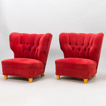 A pair of mid-20th century armchairs.