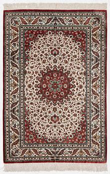 A Ghom silk rug, signed, c. 148 x 100 cm.