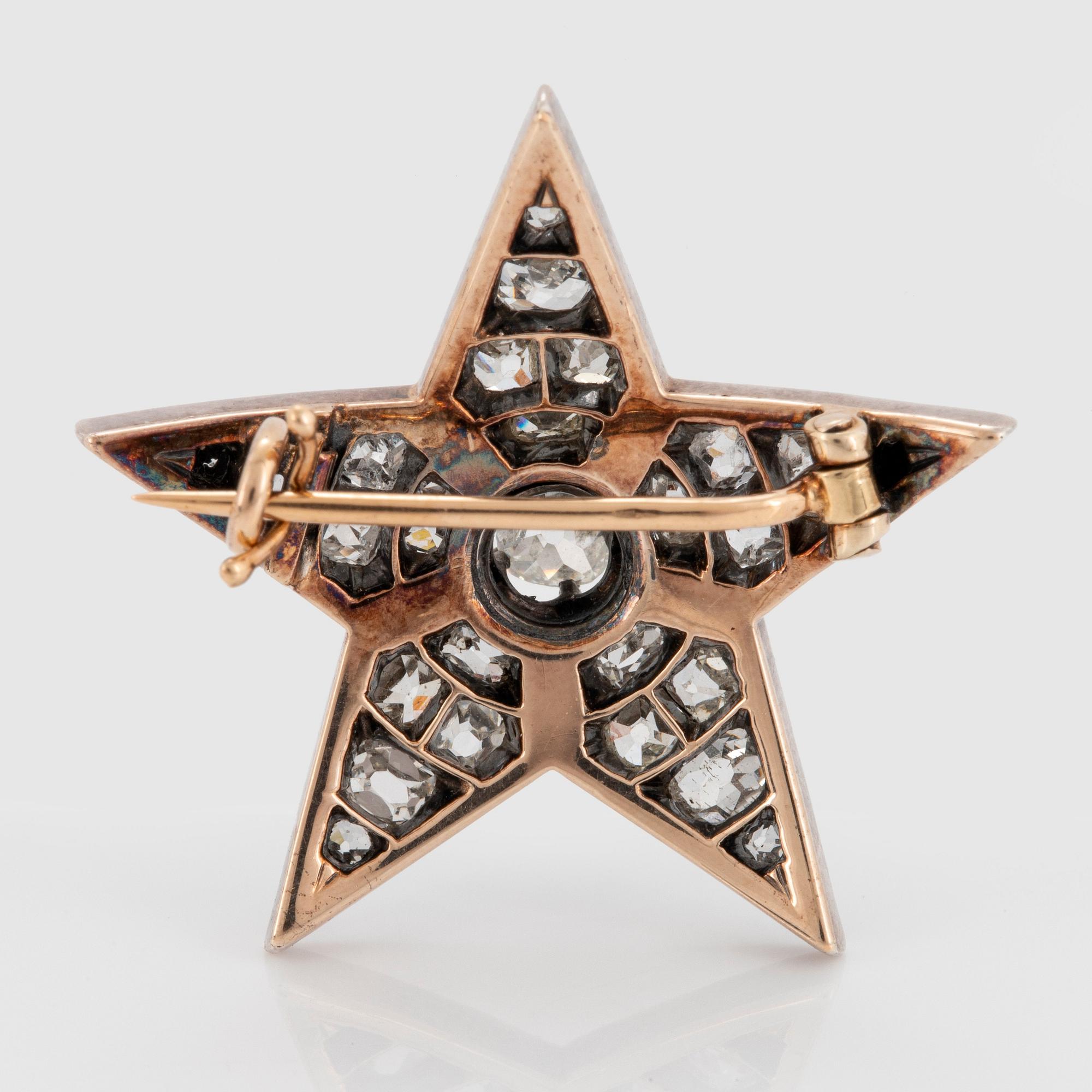 Brosch i form av stjärna silver och 14K guld med gammalslipade diamanter.