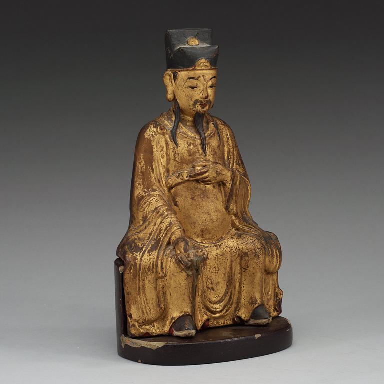 A gilt and lacquered wooden figure of a deity, Ming style.