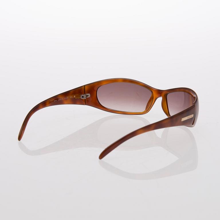 Two Pairs of Sunglasses, Prada and Chanel.