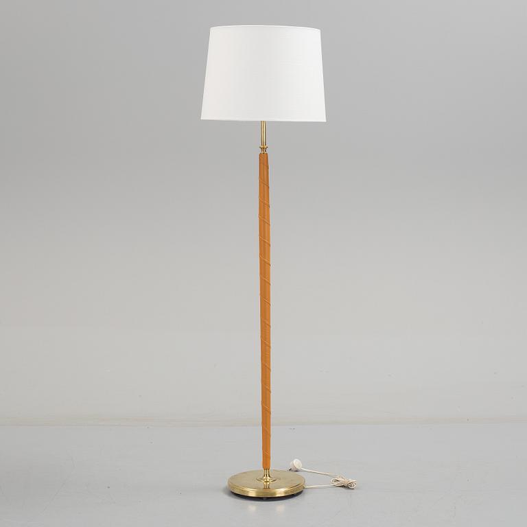 A 1960s brass and leather floor light.