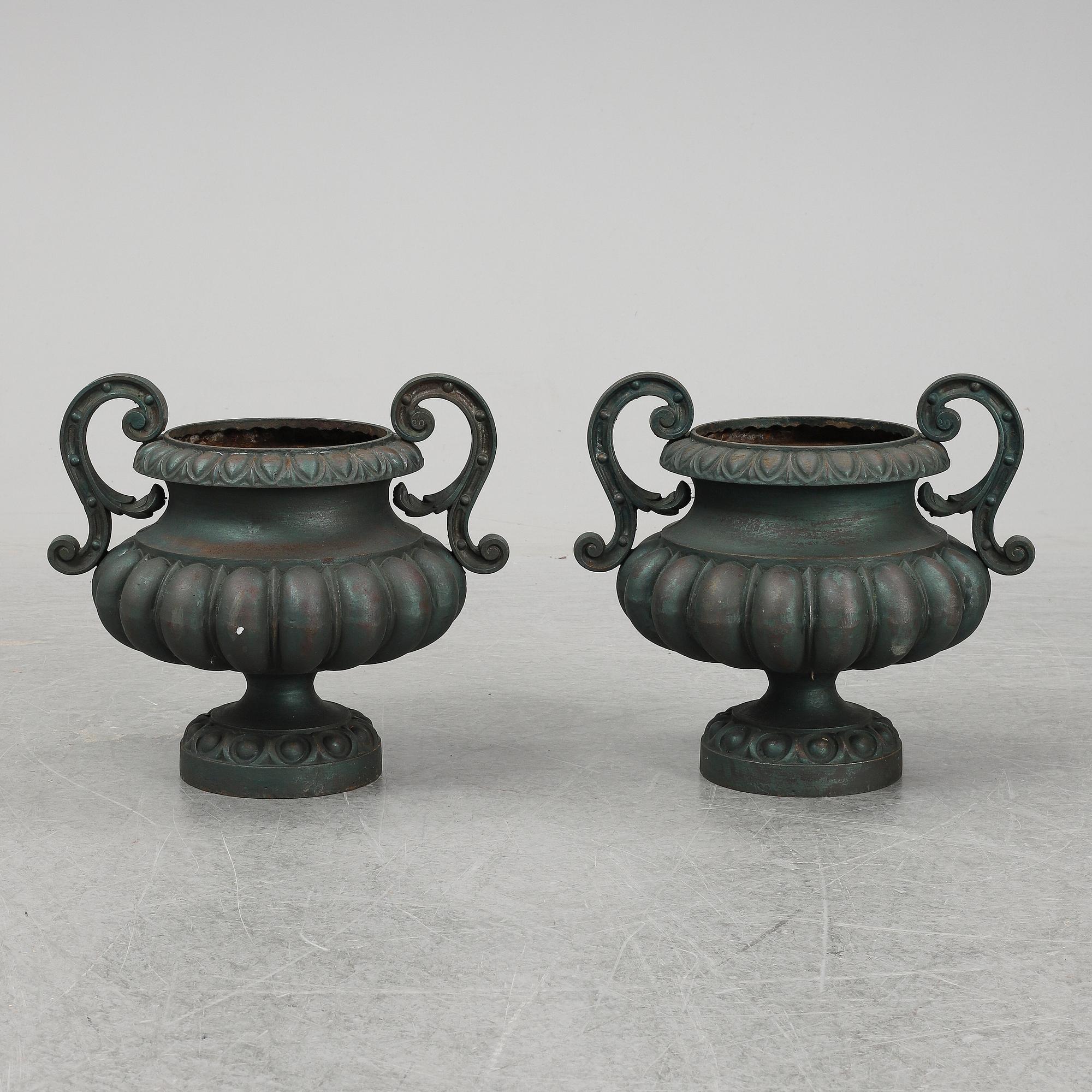 A 20th Century pair of cast iron flower pots.