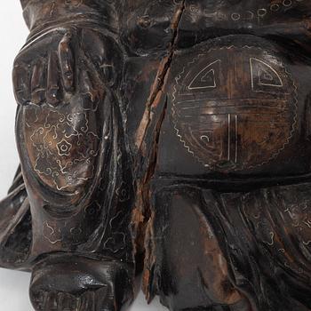 A Chinese wooden figure of Budai with silver inlays, Qing dynasty (1644-1912).