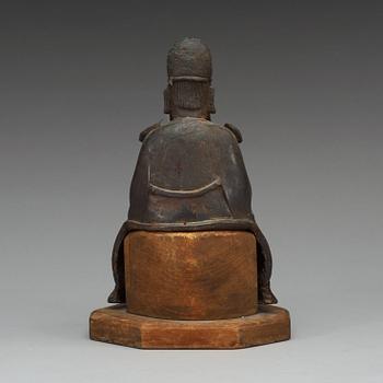 A bronze sculpture of a sitting deity, Ming dynasty (1368-1644).