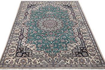 A Nain carpet, part silk, 9 laa, c. 300 x 201 cm.