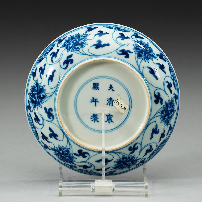 A set of four blue and white lotus dishes, Qing dynasty, with Kangxi six character mark.