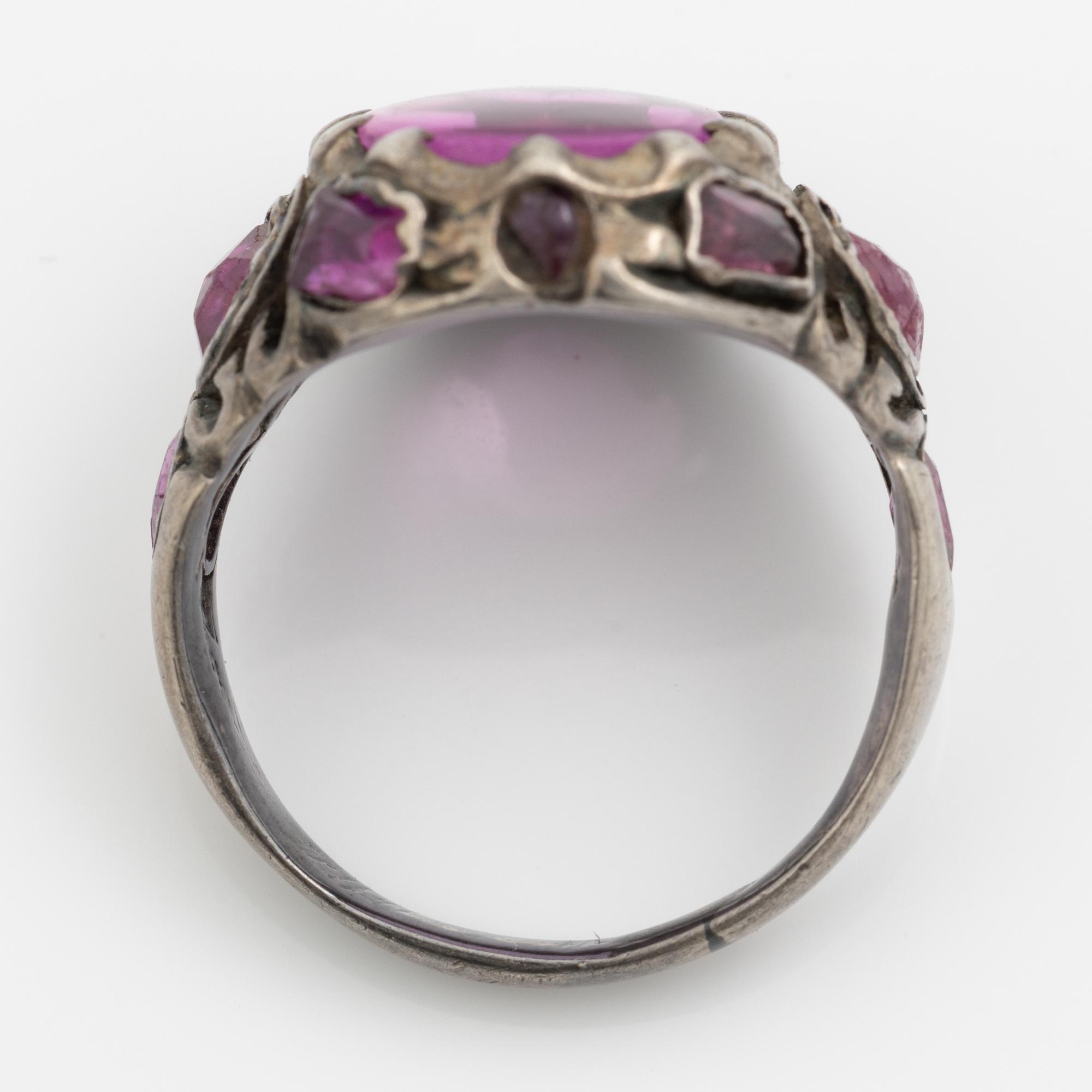 Silver ring with pink stones.