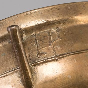 A 19th century brass cauldron.