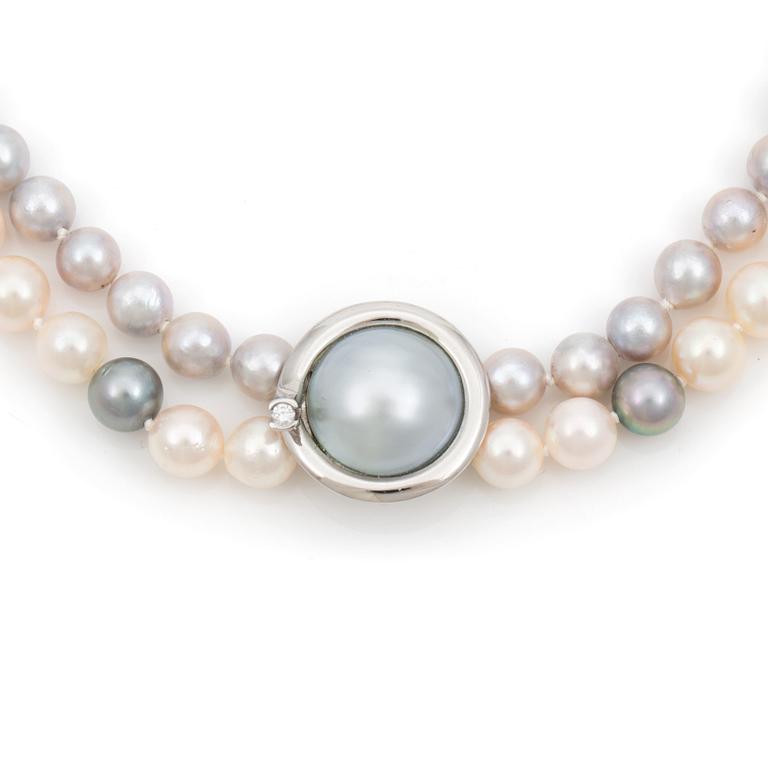 A Ole Lynggaard cultured freshwater pearl necklace. Clasp set with a cultured mabé pearl and a brilliant cut diamond.