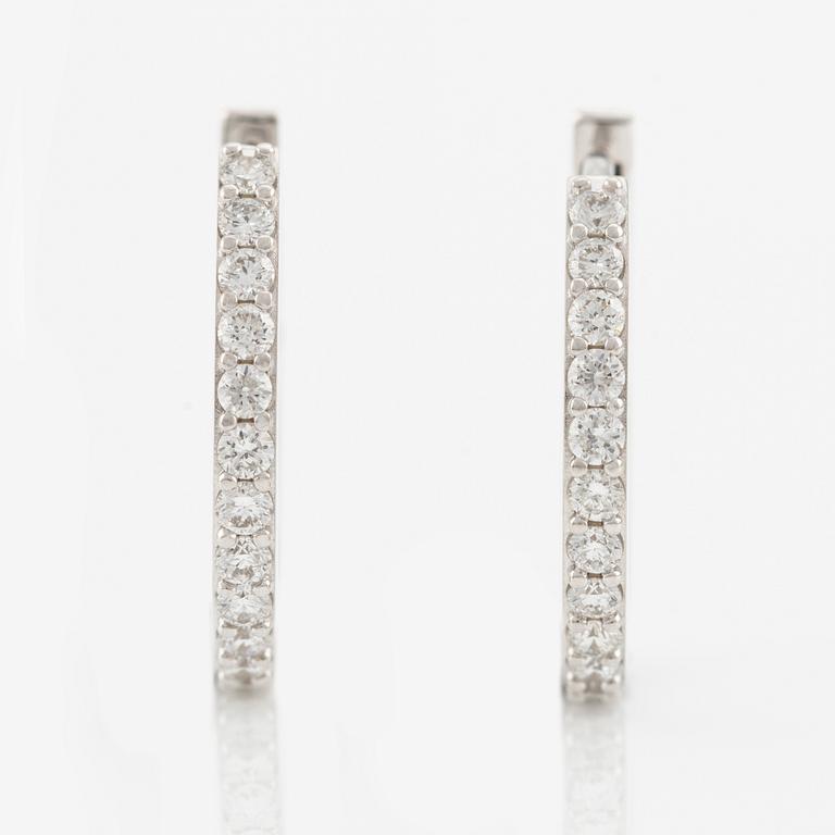 A pair of earrings in 18K white gold with round brilliant-cut diamonds.