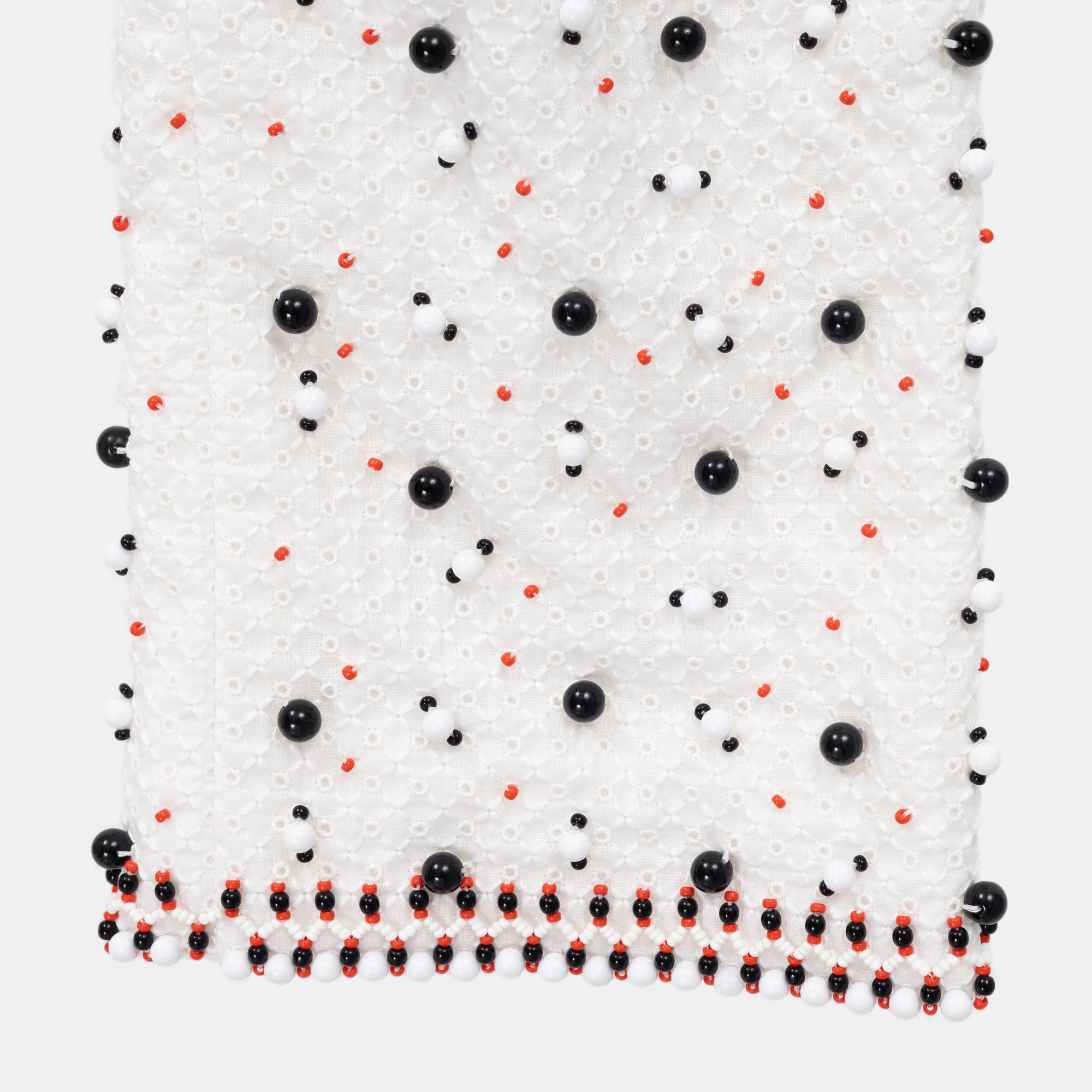 Chanel, a pair of broderie anglais trousers with pearls, size 34.