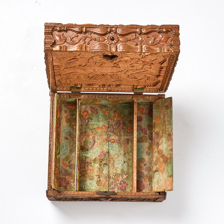 A baroque wedding casket, carved wood, dated 1725.