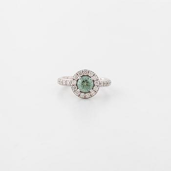A treated green diamond and briliant cut diamonds.