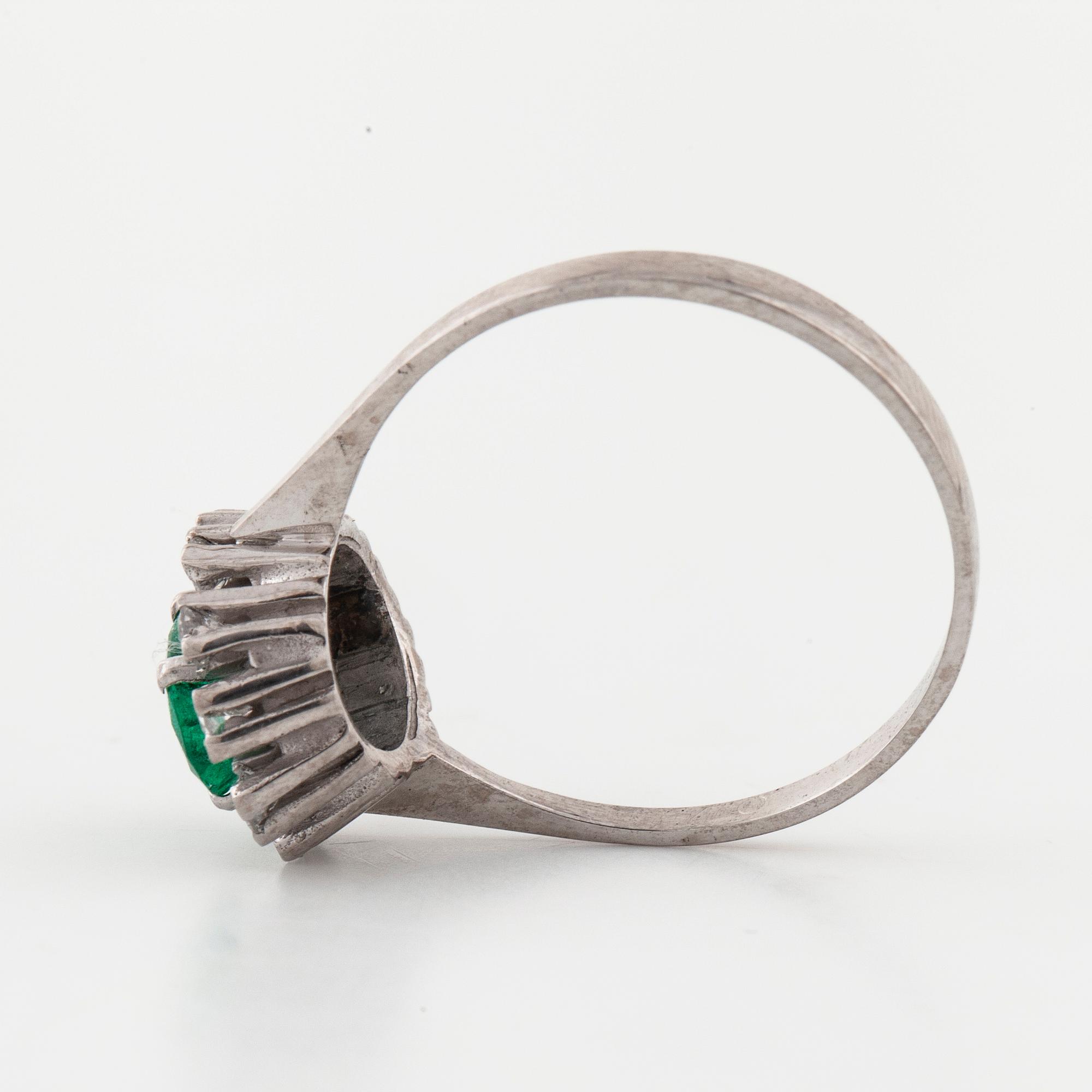 A emerald and brilliant cut diamond ring.