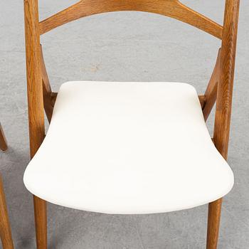 A set of six model CH 29 oak chairs by Hans J Wegner, two with leather upholstery and four with sheepskin.