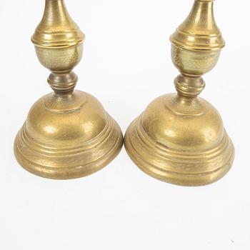 A pair of late 19th century brass candle sticks.