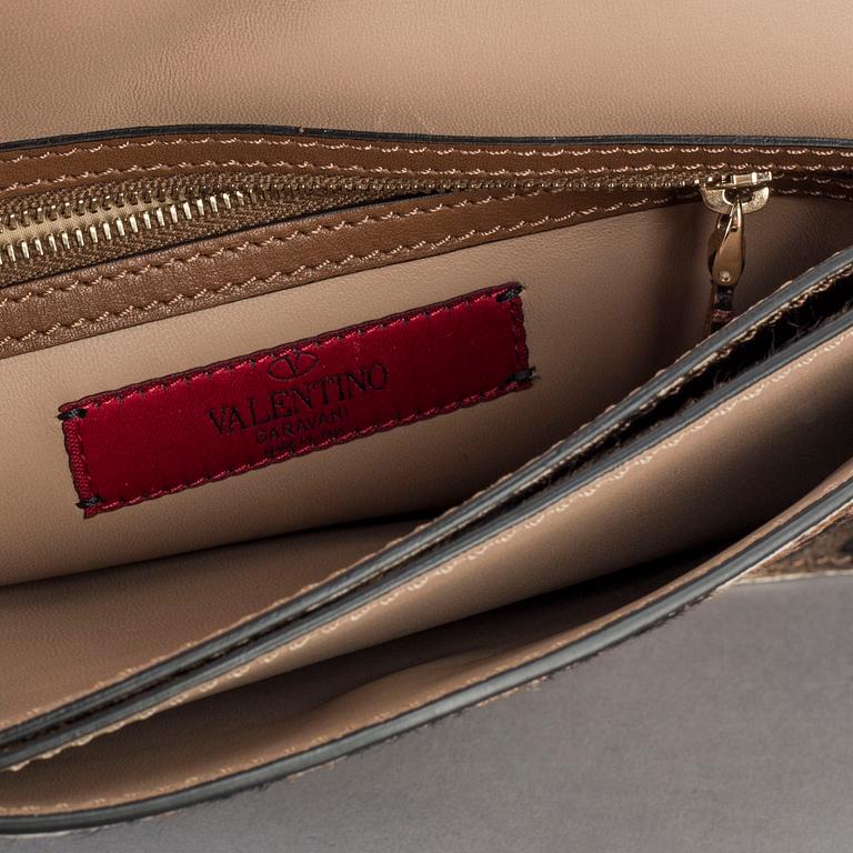 A ponyhair clutch with studs by Valentino.