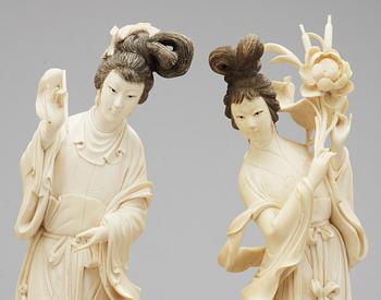 A pair of 20th Century Chines ivory figures.