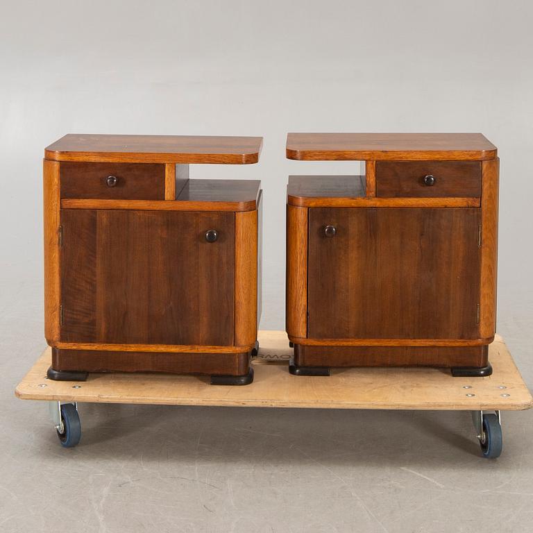 A pair of walnut/mahogany bedside tables first half of the 20th century.