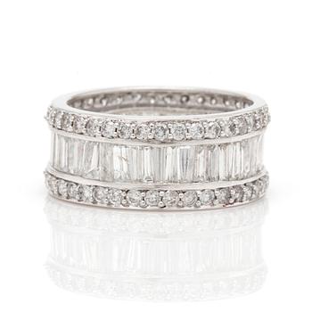 A ring with round, brilliant-cut and tapered, baguette-cut diamonds.