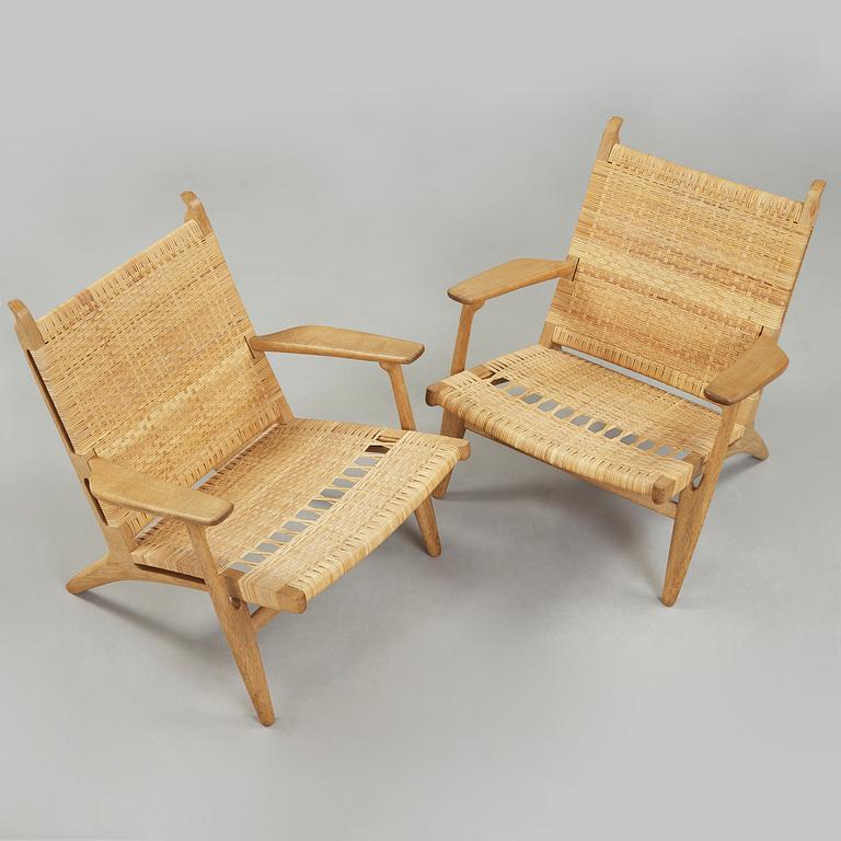 A pair of Hans J Wegner oak and rattan easy chairs 'CH-27', Carl Hansen & Son, Denmark.