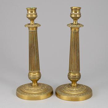 A pair of empire bronze candlesticks, first half of the 19th century.