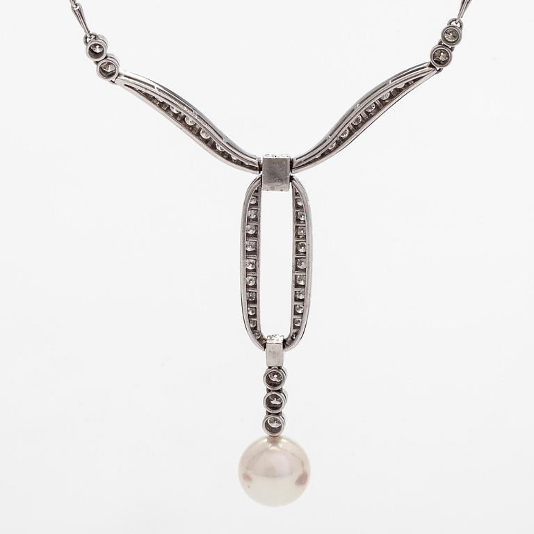 An 18K white gold necklace with brilliant-cut diamonds and a cultured pearl, England.