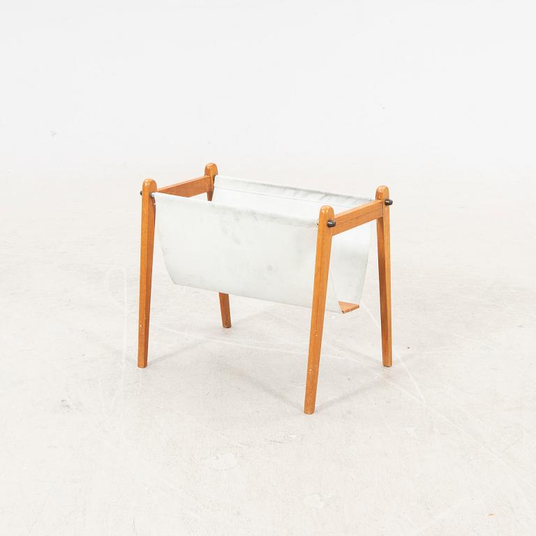 A 1960s teak newspaper holder.