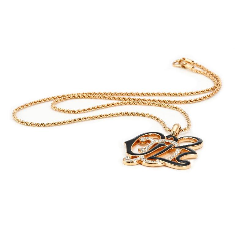 OSCAR DE LA RENTA, a gold colored necklace with pendant.