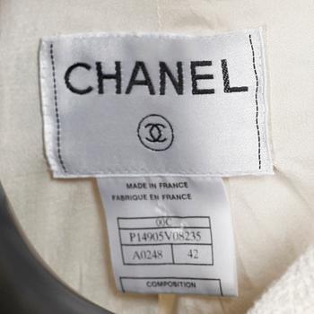 CHANEL, a white bouclé jacket.