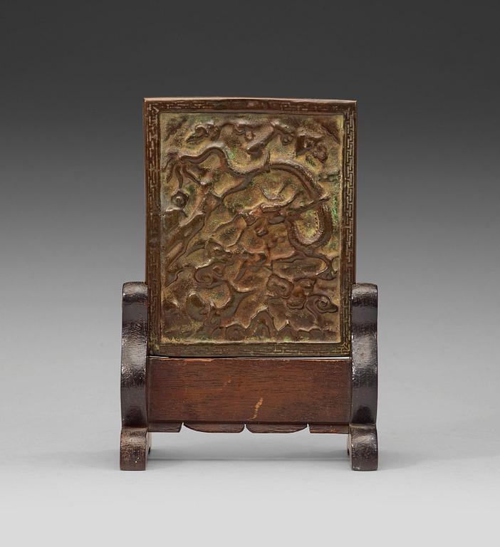A bronze table screen, Qing dynasty.