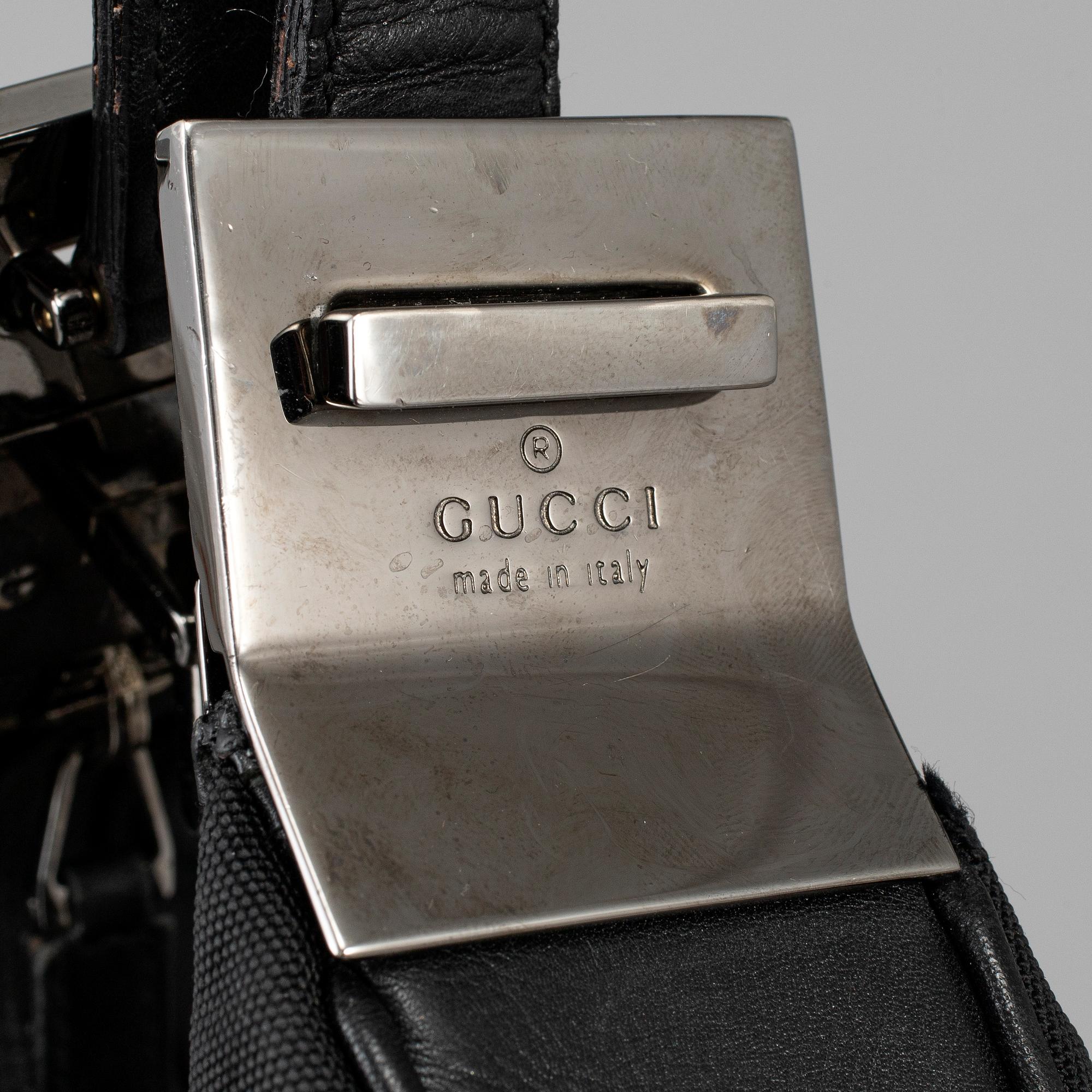 GUCCI, a canvas handbag.